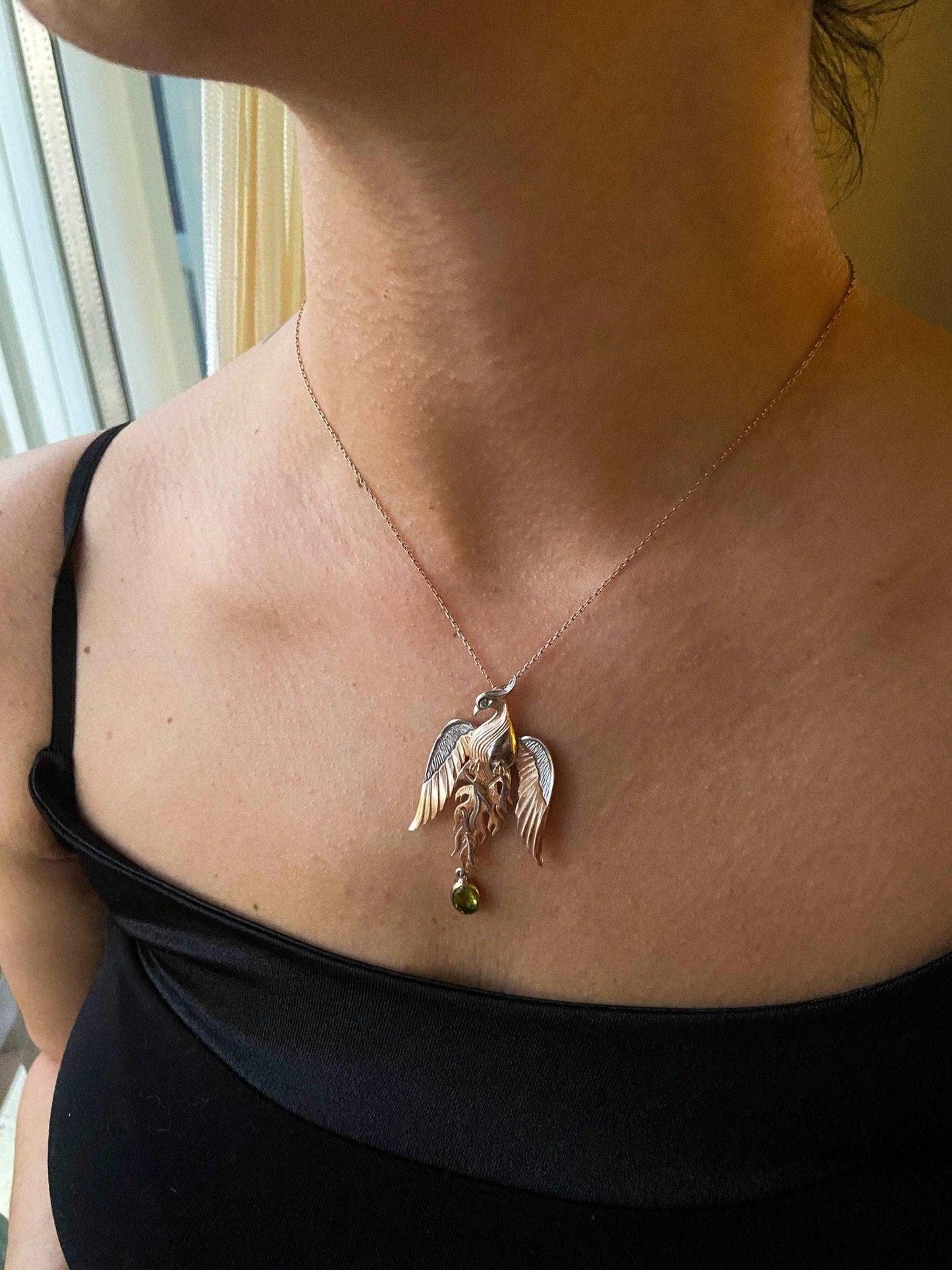 Peridot Gemstone Emerald Eye Fire Bird Phoenix 925 Sterling Silver NecPeridot Gemstone Our phoenix is 925 sterling silver and it is completely handcrafted. The eyes you see on it are decorated with emeralds.
It is specially designed Peridot Gemstone