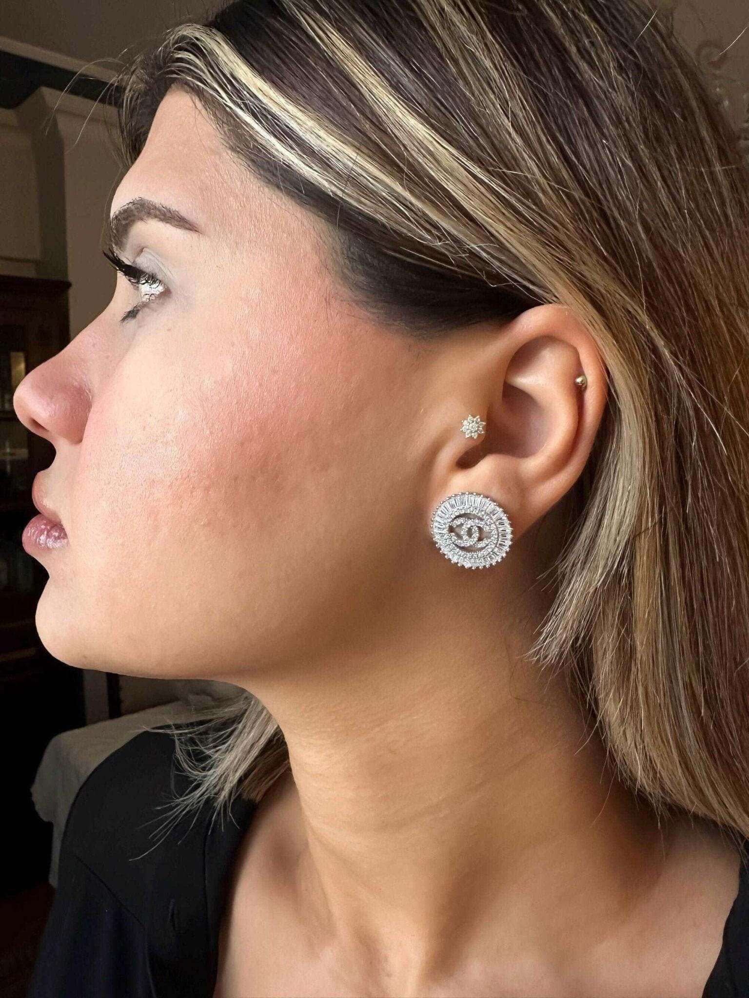 Authentic Chanel Jewelry 925 sterling silver earrings with baguette stones worn by woman