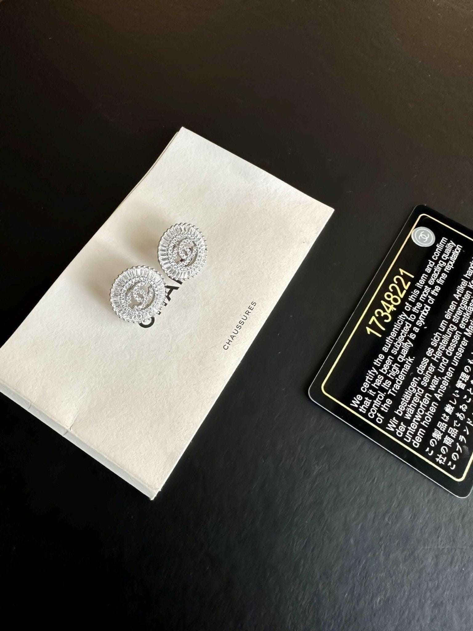 Authentic Chanel Jewelry 925 sterling silver earrings with baguette stones on white Chanel box