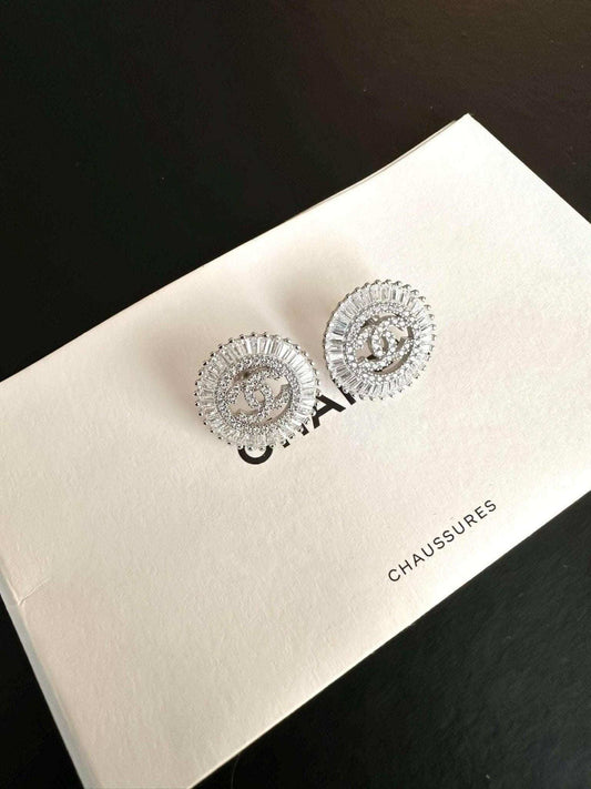 Authentic Chanel Jewelry 925 sterling silver earrings with baguette stones on white box
