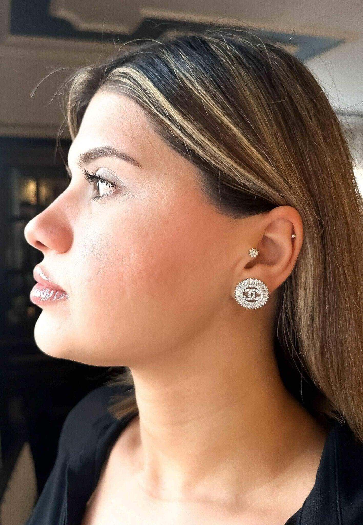 Authentic Chanel Jewelry 925 sterling silver earrings with baguette stones worn by woman