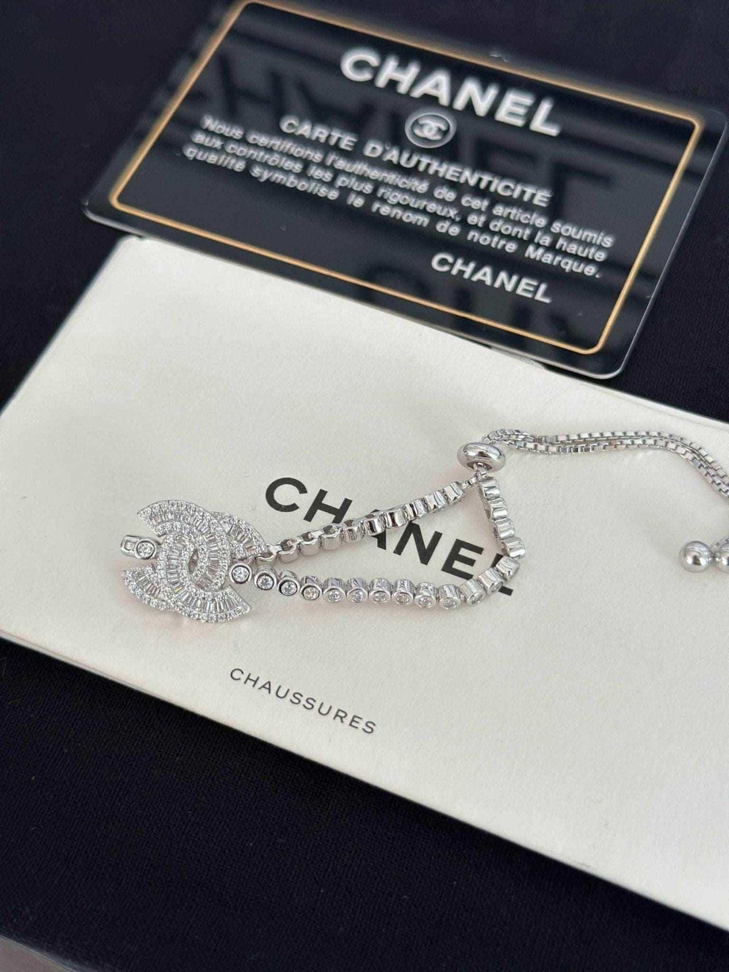 Exquisite 925 Sterling Silver Chanel Bracelet with Brilliant White Zircon Stone - Timeless Elegance displayed with authentication card.