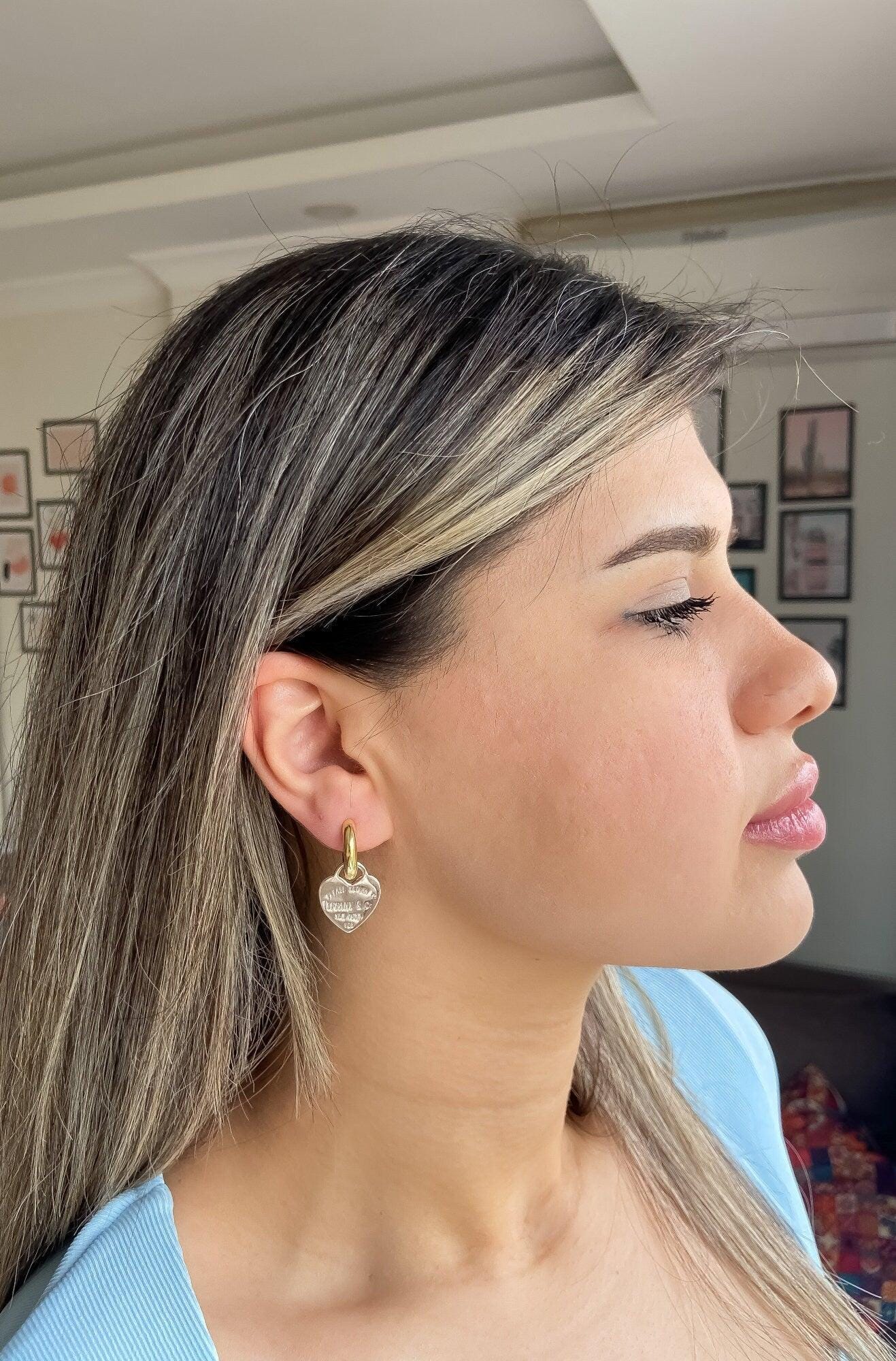 925 Sterling Silver Tiffany & Co Gold Planet Jewelry Heart Earrings worn by a woman.