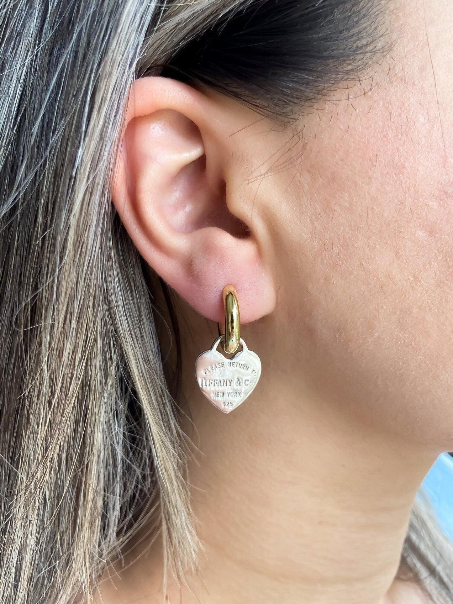 925 Sterling Silver Tiffany & Co Gold Planet Jewelry Heart Earrings worn by a woman, showcasing their elegant design.
