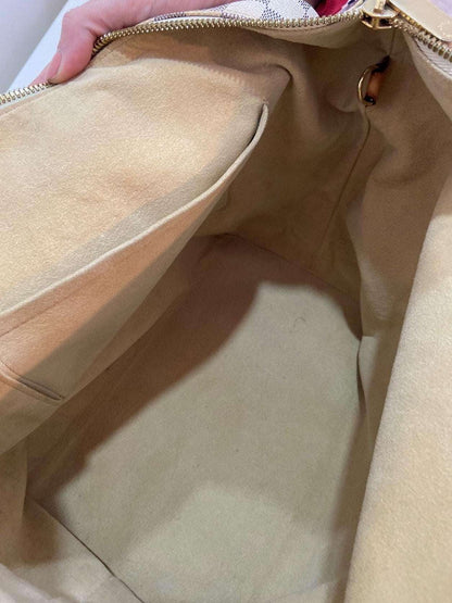 Louis Vuitton Damier Azur Saleya MM tote bag interior view showing clean beige lining and pocket