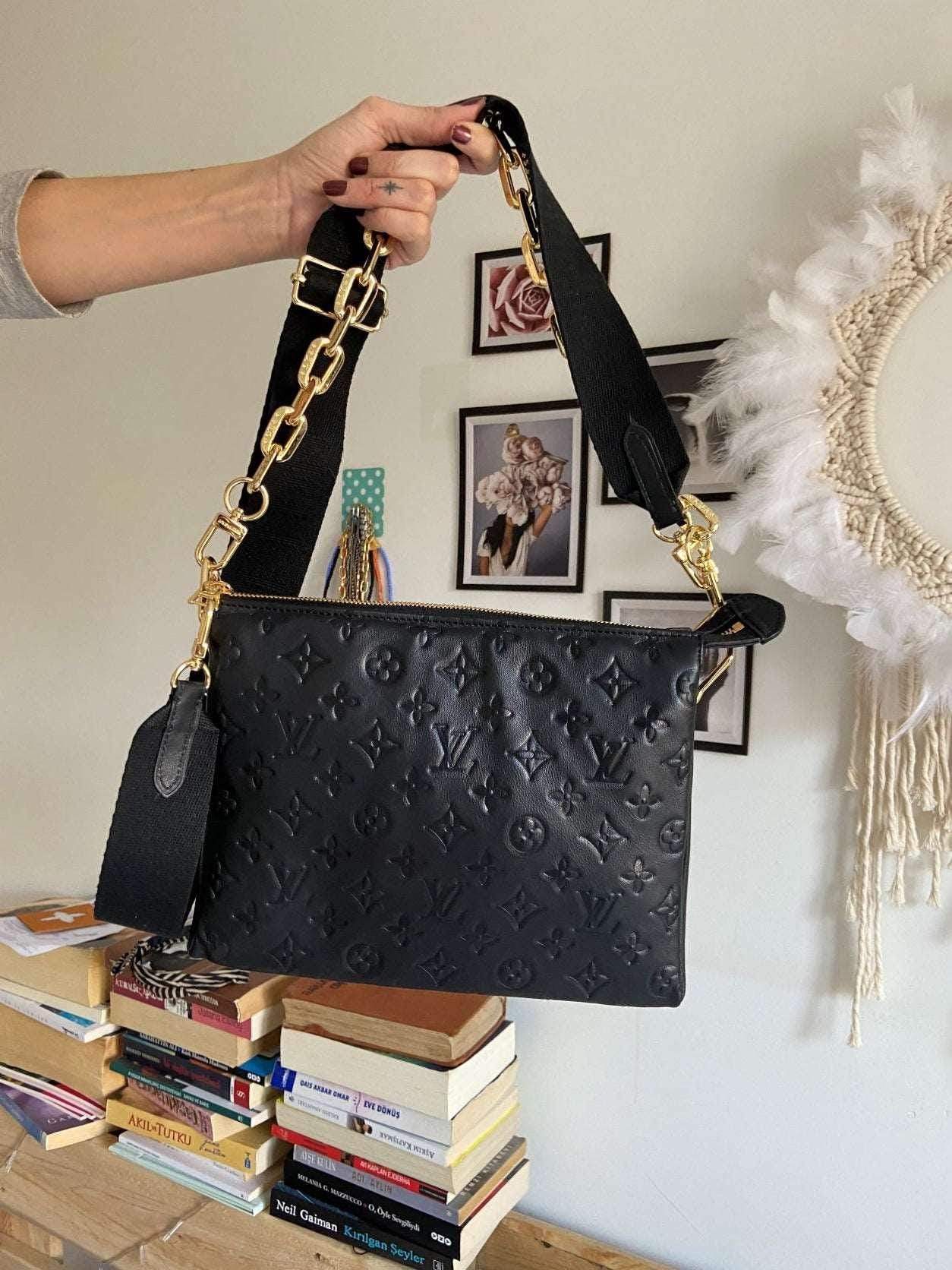Black Louis Vuitton COUSSIN PM handbag in monogram-embossed puffy lambskin with gold hardware and removable strap