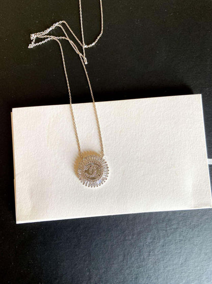 Vintage Chanel Necklace 925 sterling silver with baguette stones on chain displayed on white card