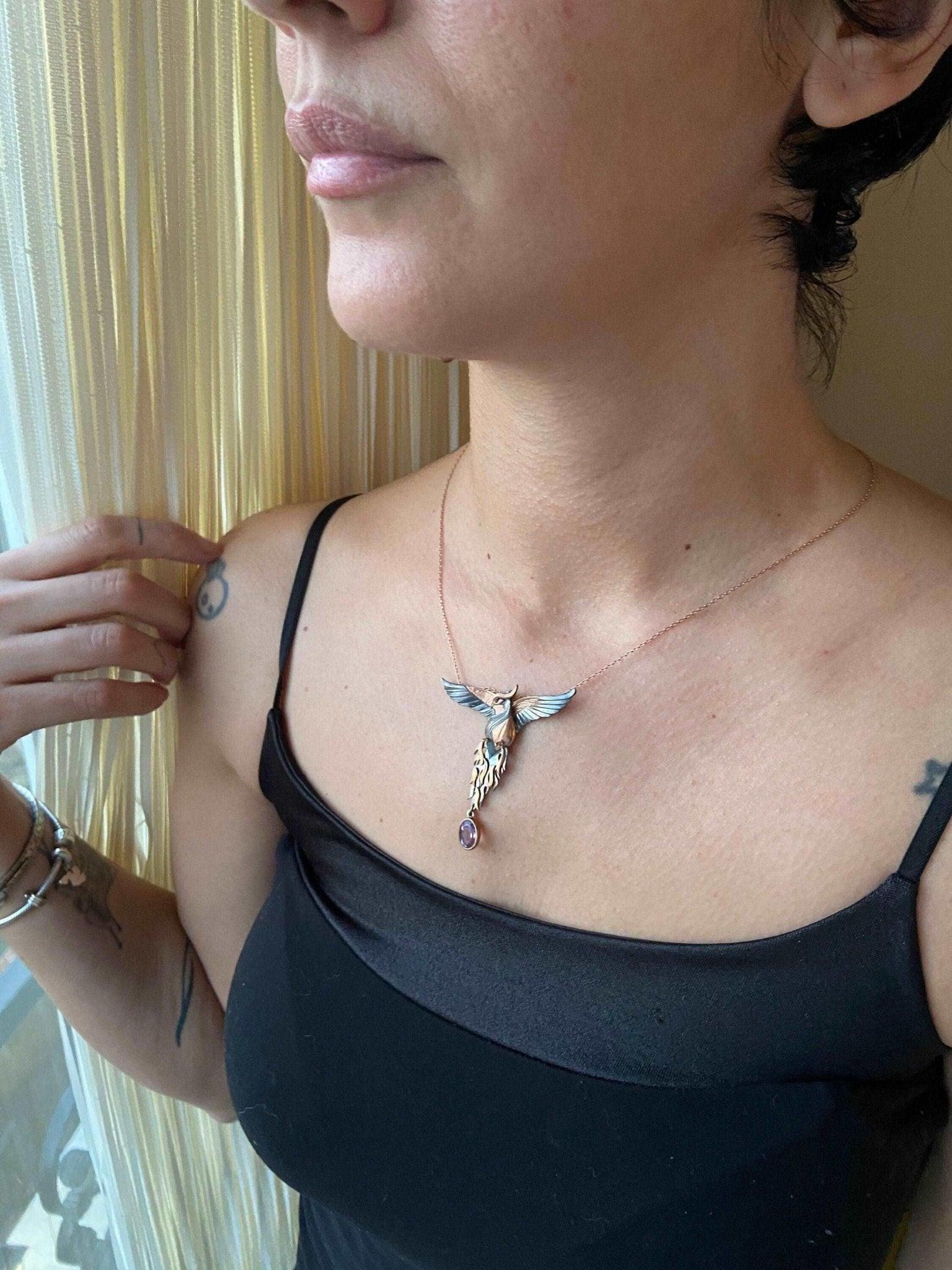 Amethyst Stone Fire Bird Pendant, Custom Desing Phoenix 925 Sterling SAmethyst Gemstone Our phoenix is ​​925 sterling silver and it is completely handcrafted. The eyes you see on it are decorated with red emeralds. It is specially desiAmethyst Stone Fire Bird Pendant