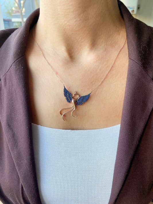 Blue Phoenix Handmade Necklace, Bird Jewelry Rose Gold Firebird PendanWe designed our 925 firebird necklace for you. It is completely handcrafted and made of sterling silver. It is decorated with rose gold and Purple colored zircon stoBlue Phoenix Handmade Necklace