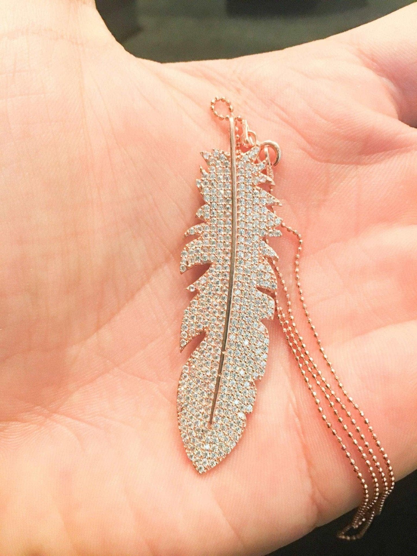 Feather Silver Necklace Custom Desing White Zircon Gemstone Rose Gold We designed it in the form of a feather decorated with diamond cut zircon stones on 925 Sterling silver. It is a bright and impressive eye-catching necklace. All stoFeather Silver Necklace