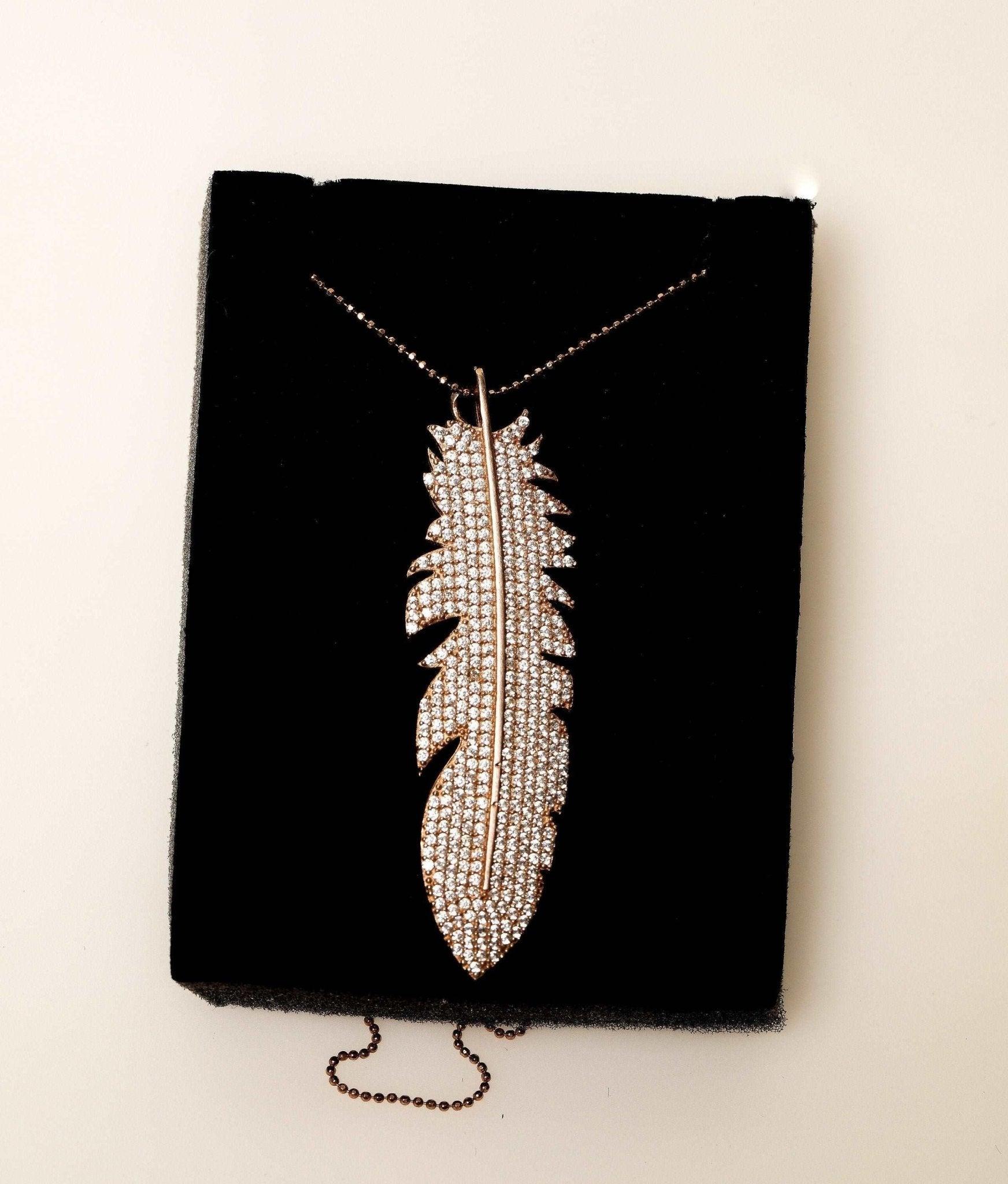 Feather Silver Necklace Custom Desing White Zircon Gemstone Rose Gold We designed it in the form of a feather decorated with diamond cut zircon stones on 925 Sterling silver. It is a bright and impressive eye-catching necklace. All stoFeather Silver Necklace