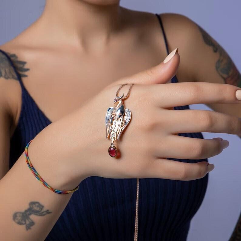 Garnet Stone Handmade Phoenix Root Ruby Eye Silver Necklace, Garnet GeGarnet Gemstone Our phoenix is ​​925 sterling silver and it is completely handcrafted. The eyes you see on it are decorated with red ruby. It is specially designed tNecklaceGarnet Stone