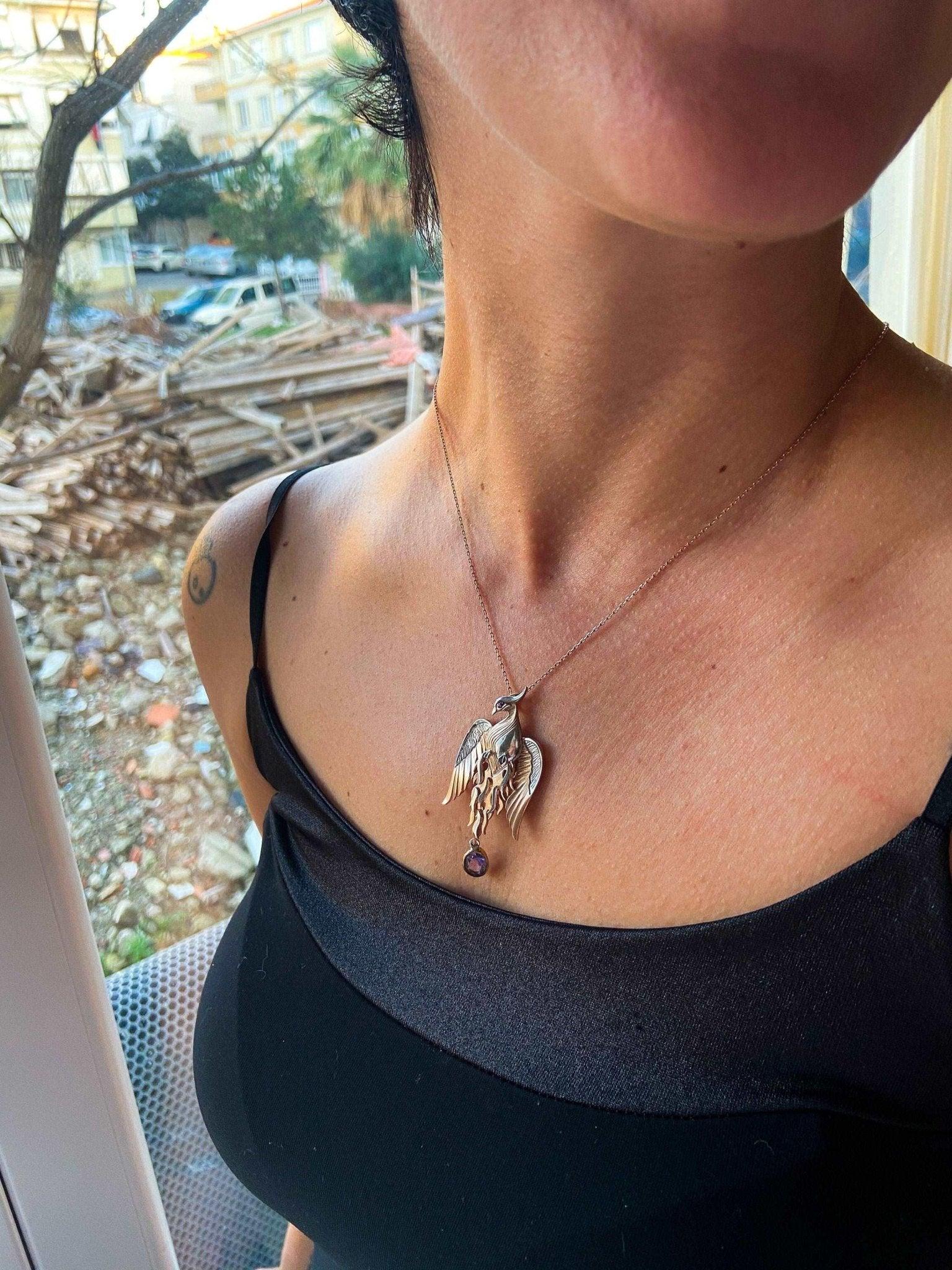 Phoenix Strength Amethyst Stone Firebird 925 Sterling Silver Pendant, Amethyst Gemstone Our phoenix is ​​925 sterling silver and it is completely handcrafted. The eyes you see on it are decorated with red ruby. It is specially designedNecklacePhoenix Strength Amethyst