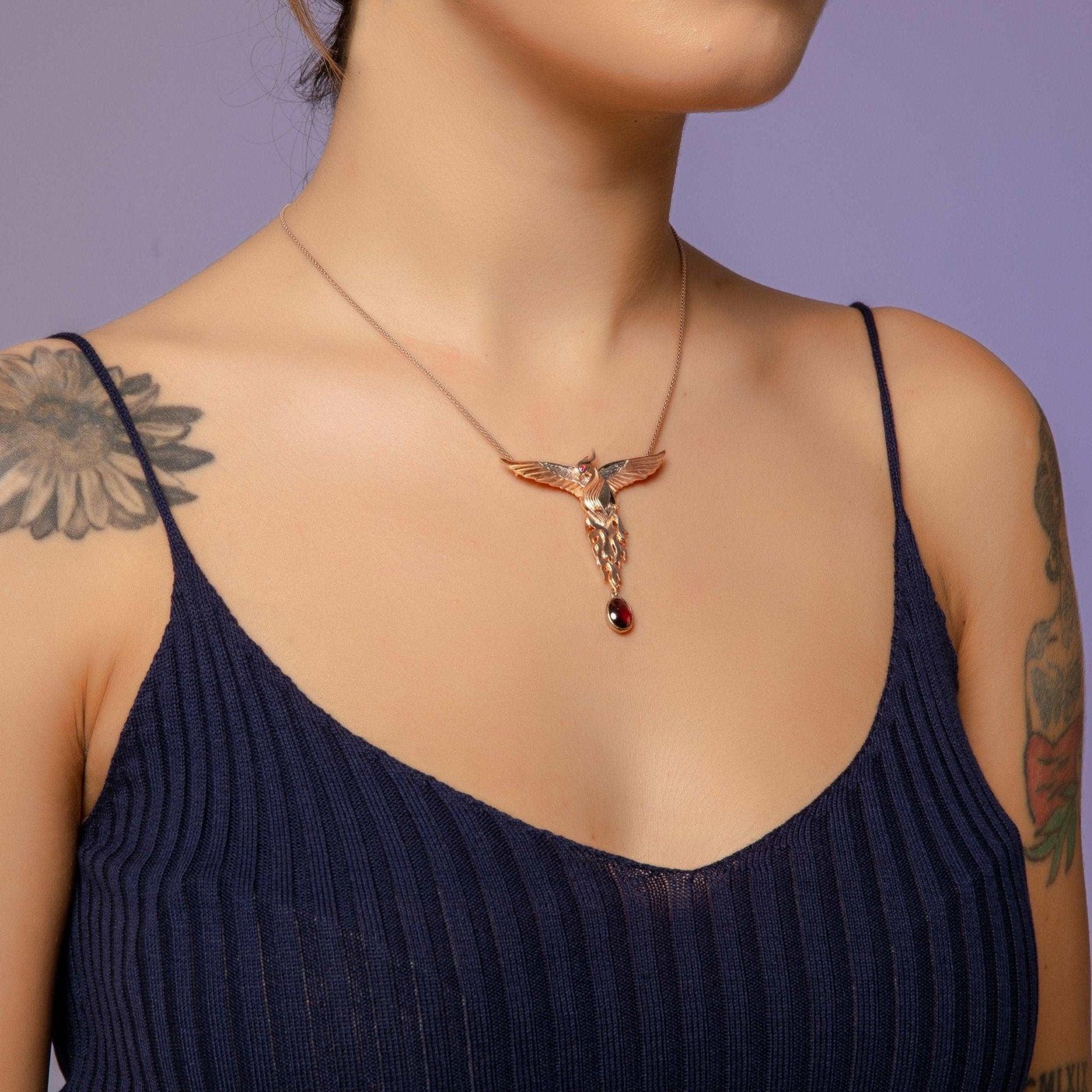 Phoenix Strength Root Ruby Pendant, Firebird Handmade 925 Sterling SilOur phoenix is ​​925 sterling silver and it is completely handcrafted. The eyes you see on it are decorated with red emeralds. It is specially designed to open and cPhoenix Strength Root Ruby