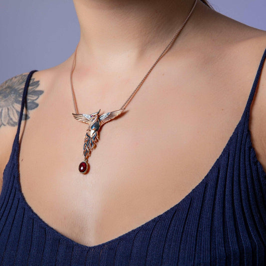 Phoenix Strength Root Ruby Pendant, Firebird Handmade 925 Sterling SilOur phoenix is ​​925 sterling silver and it is completely handcrafted. The eyes you see on it are decorated with red emeralds. It is specially designed to open and cPhoenix Strength Root Ruby