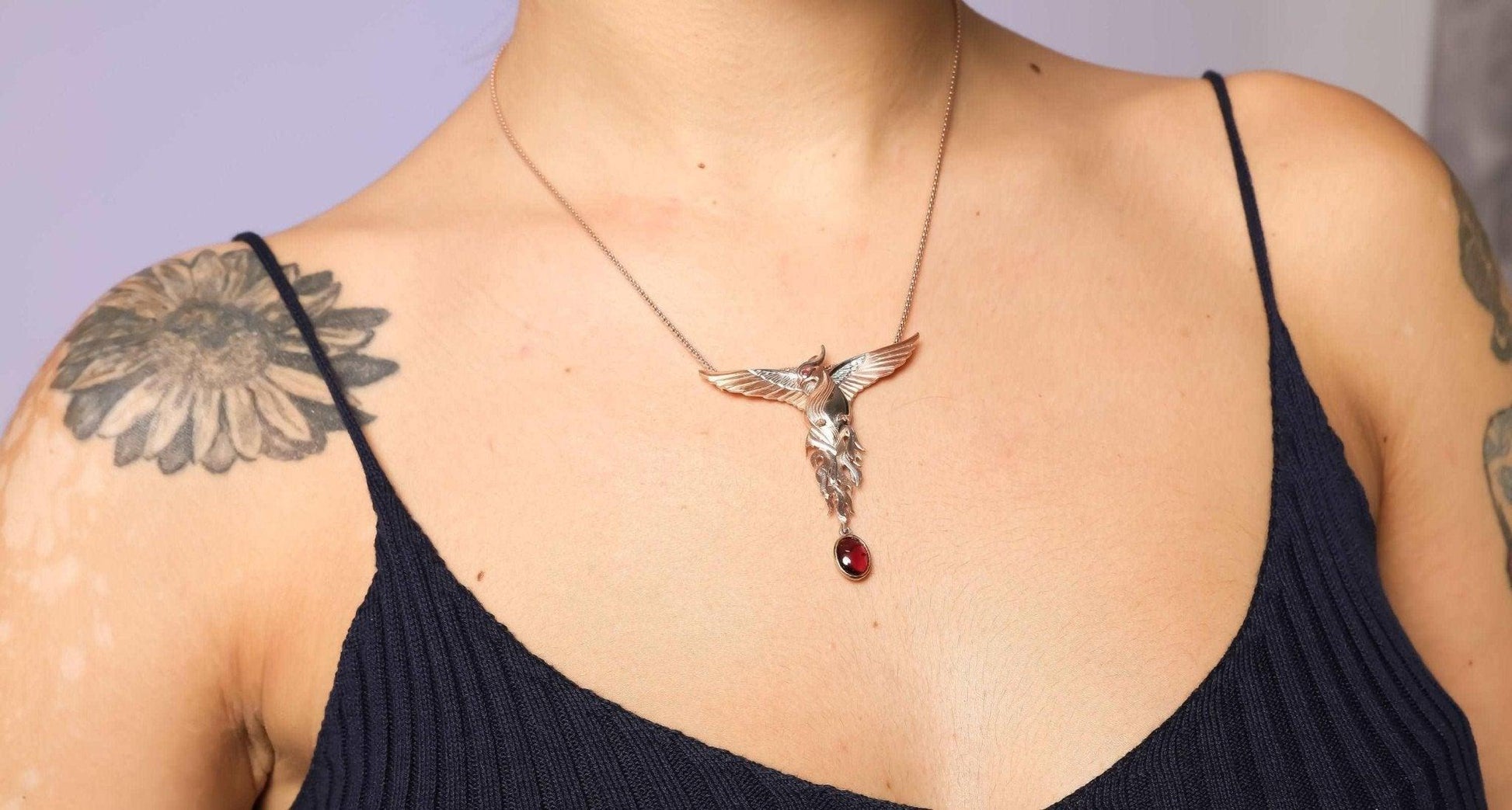 Phoenix Strength Root Ruby Pendant, Firebird Handmade 925 Sterling SilOur phoenix is ​​925 sterling silver and it is completely handcrafted. The eyes you see on it are decorated with red emeralds. It is specially designed to open and cPhoenix Strength Root Ruby