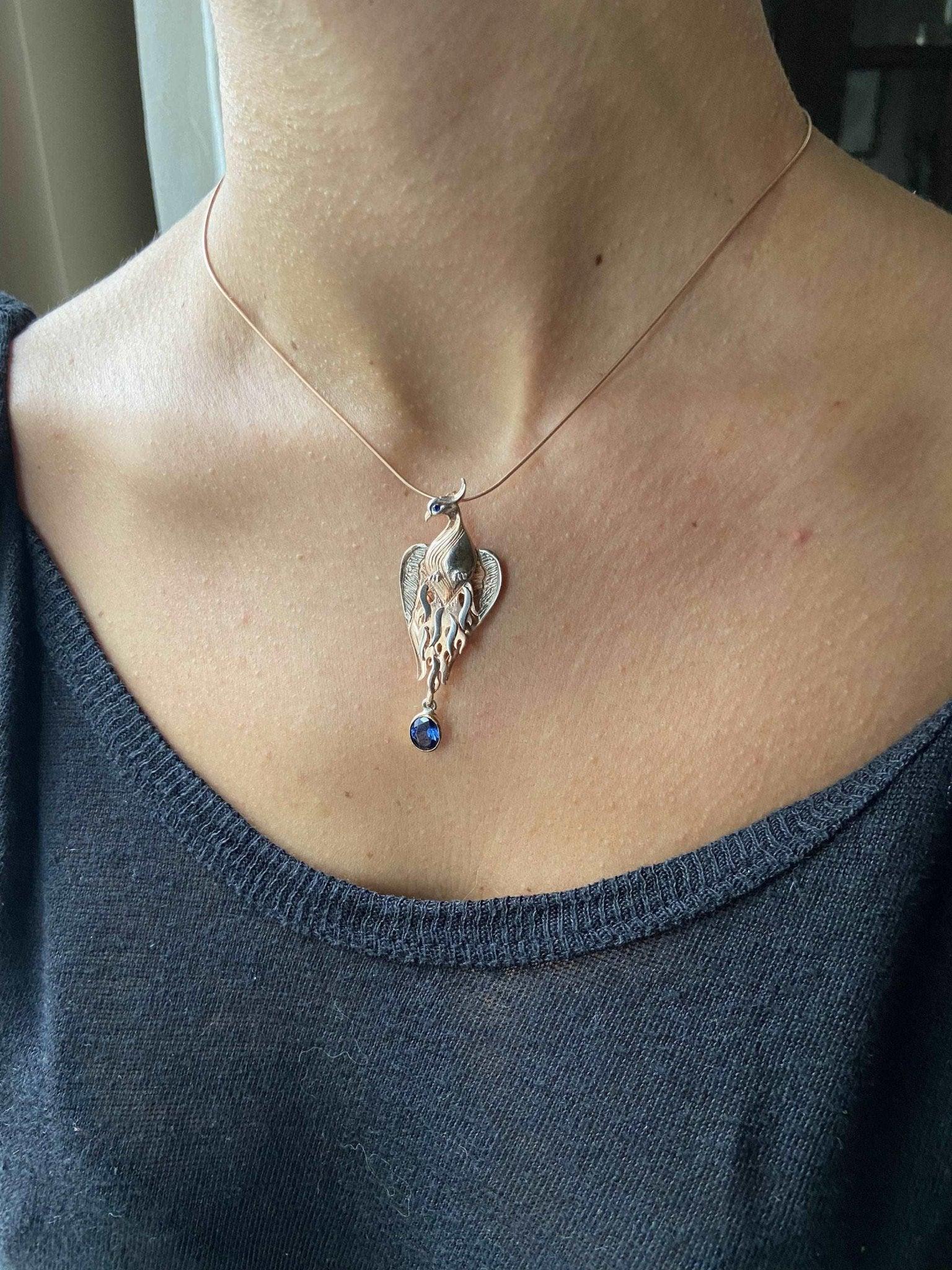 Phoenix Strength Sapphire Stone Firebird 925 Sterling Silver Pendant, Sapphire Gemstone Our phoenix is ​​925 sterling silver and it is completely handcrafted. The eyes you see on it are decorated with Blue sapphire. It is specially desPhoenix Strength Sapphire Stone