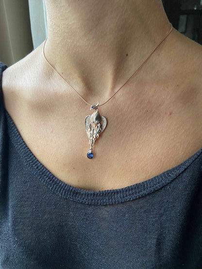 Phoenix Strength Sapphire Stone Firebird 925 Sterling Silver Pendant, Sapphire Gemstone Our phoenix is ​​925 sterling silver and it is completely handcrafted. The eyes you see on it are decorated with Blue sapphire. It is specially desPhoenix Strength Sapphire Stone