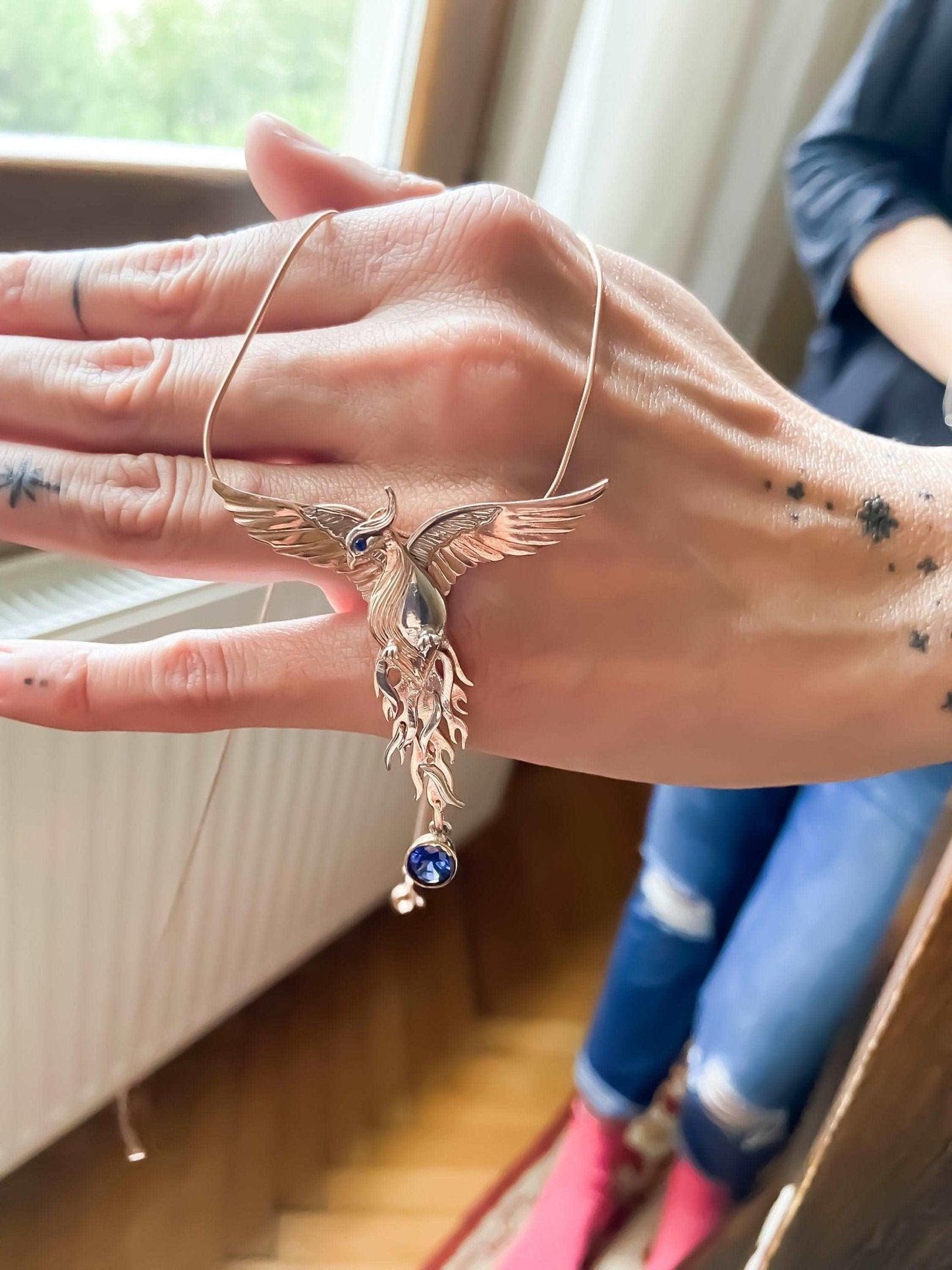 Phoenix Strength Sapphire Stone Firebird 925 Sterling Silver Pendant, Sapphire Gemstone Our phoenix is ​​925 sterling silver and it is completely handcrafted. The eyes you see on it are decorated with Blue sapphire. It is specially desPhoenix Strength Sapphire Stone
