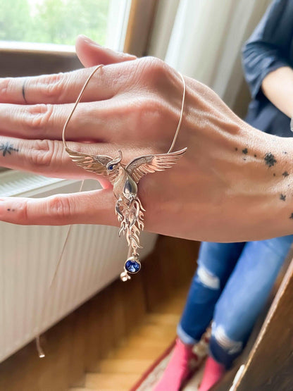 Phoenix Strength Sapphire Stone Firebird 925 Sterling Silver Pendant, Sapphire Gemstone Our phoenix is ​​925 sterling silver and it is completely handcrafted. The eyes you see on it are decorated with Blue sapphire. It is specially desPhoenix Strength Sapphire Stone