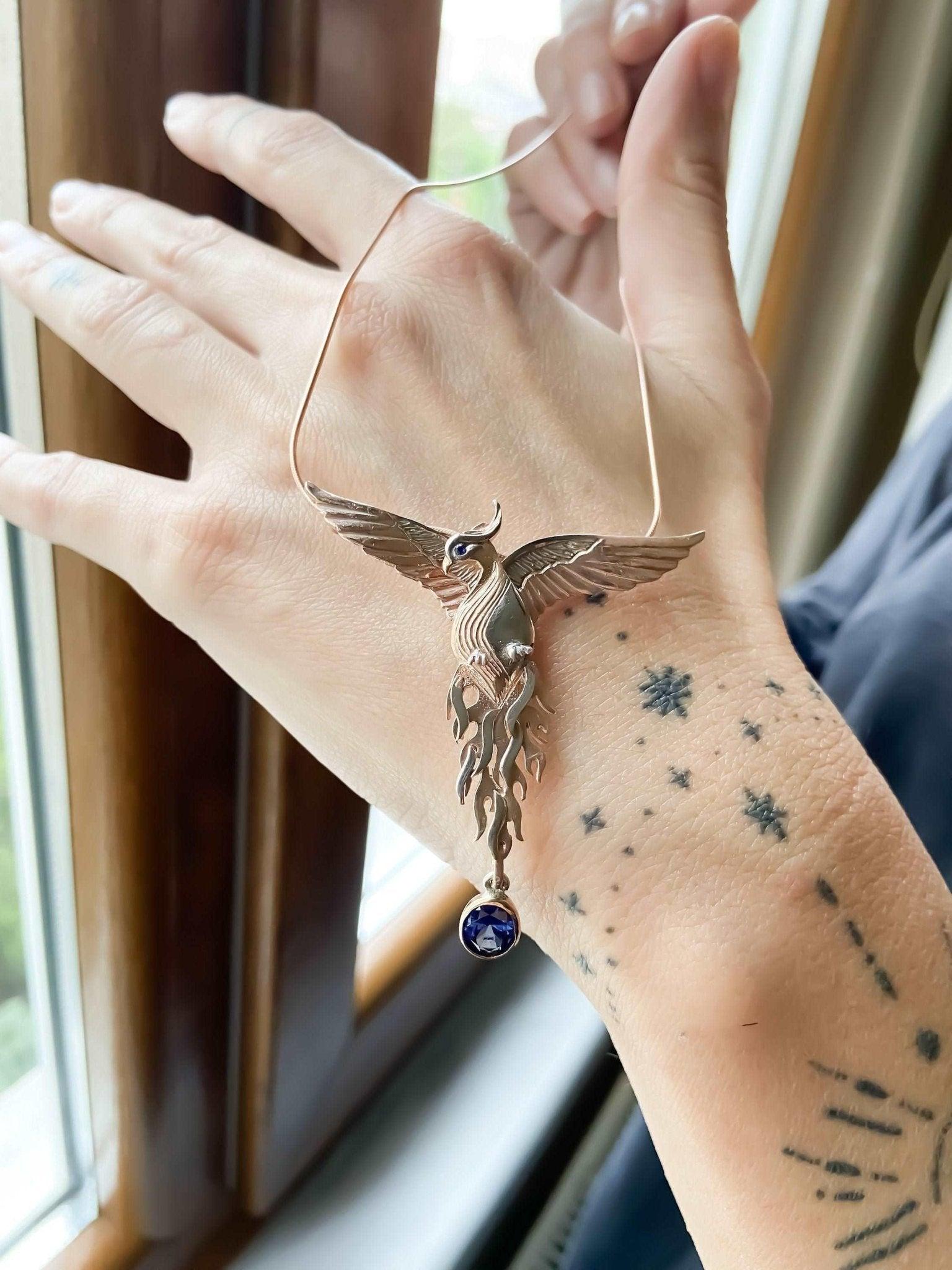 Phoenix Strength Sapphire Stone Firebird 925 Sterling Silver Pendant, Sapphire Gemstone Our phoenix is ​​925 sterling silver and it is completely handcrafted. The eyes you see on it are decorated with Blue sapphire. It is specially desPhoenix Strength Sapphire Stone