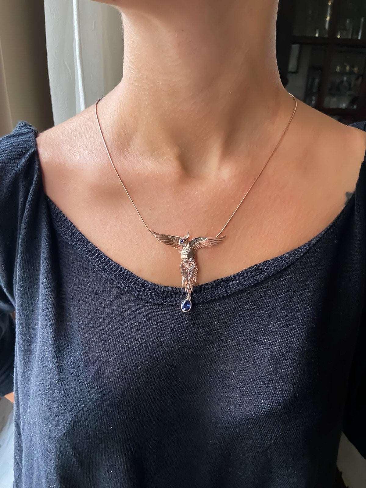Phoenix Strength Sapphire Stone Firebird 925 Sterling Silver Pendant, Sapphire Gemstone Our phoenix is ​​925 sterling silver and it is completely handcrafted. The eyes you see on it are decorated with Blue sapphire. It is specially desPhoenix Strength Sapphire Stone