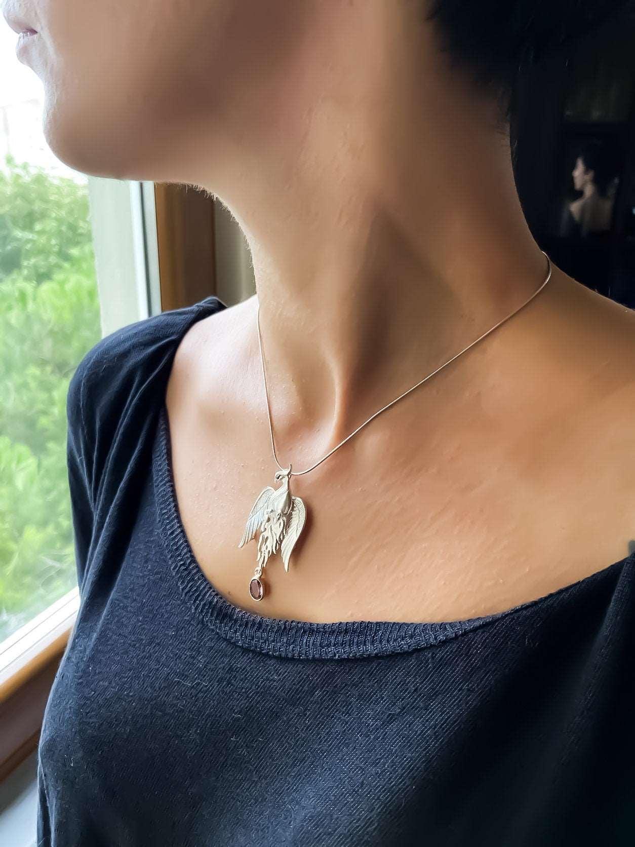 Pure Silver Firebird Strength Phoenix 925 Sterling Silver Necklace, HaAmethyst Stone Sapphire Eye Pure Silver Our phoenix is ​​925 sterling silver and it is completely handcrafted. The eyes you see on it are decorated with Blue sapphirPure Silver Firebird