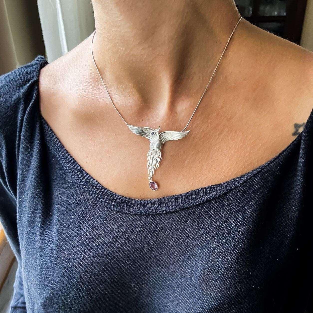 Pure Silver Firebird Strength Phoenix 925 Sterling Silver Necklace, HaAmethyst Stone Sapphire Eye Pure Silver Our phoenix is ​​925 sterling silver and it is completely handcrafted. The eyes you see on it are decorated with Blue sapphirPure Silver Firebird