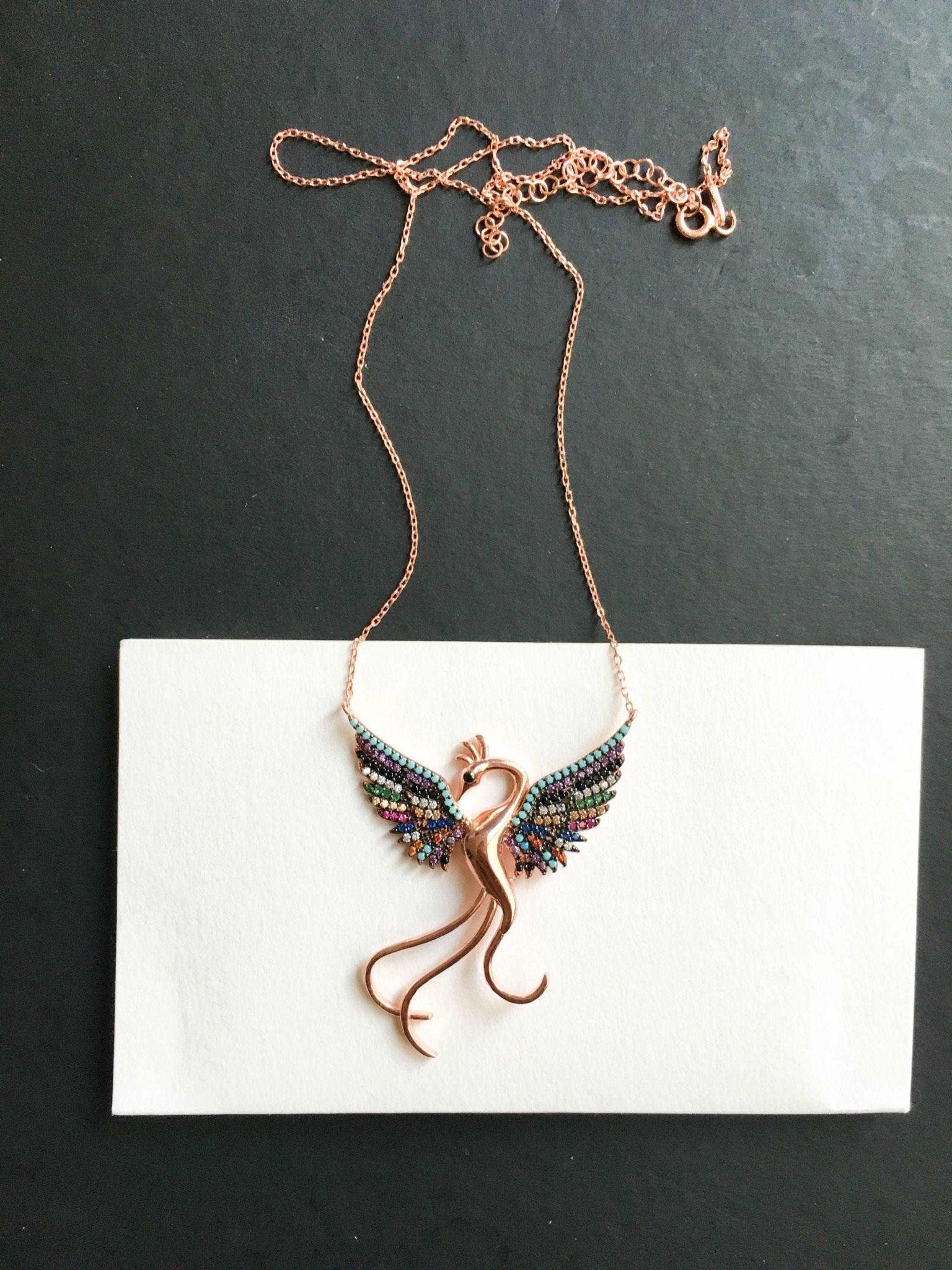Rainbow Phoenix Necklace,Custom Desing Firebird Handmade Jewelry StrenWe designed our 925 carat fire bird necklace for you. It is completely handcrafted and made of sterling silver. It is decorated with rose gold and colored zircon stoRainbow Phoenix Necklace