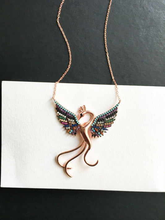 Rainbow Phoenix Necklace,Custom Desing Firebird Handmade Jewelry StrenWe designed our 925 carat fire bird necklace for you. It is completely handcrafted and made of sterling silver. It is decorated with rose gold and colored zircon stoRainbow Phoenix Necklace