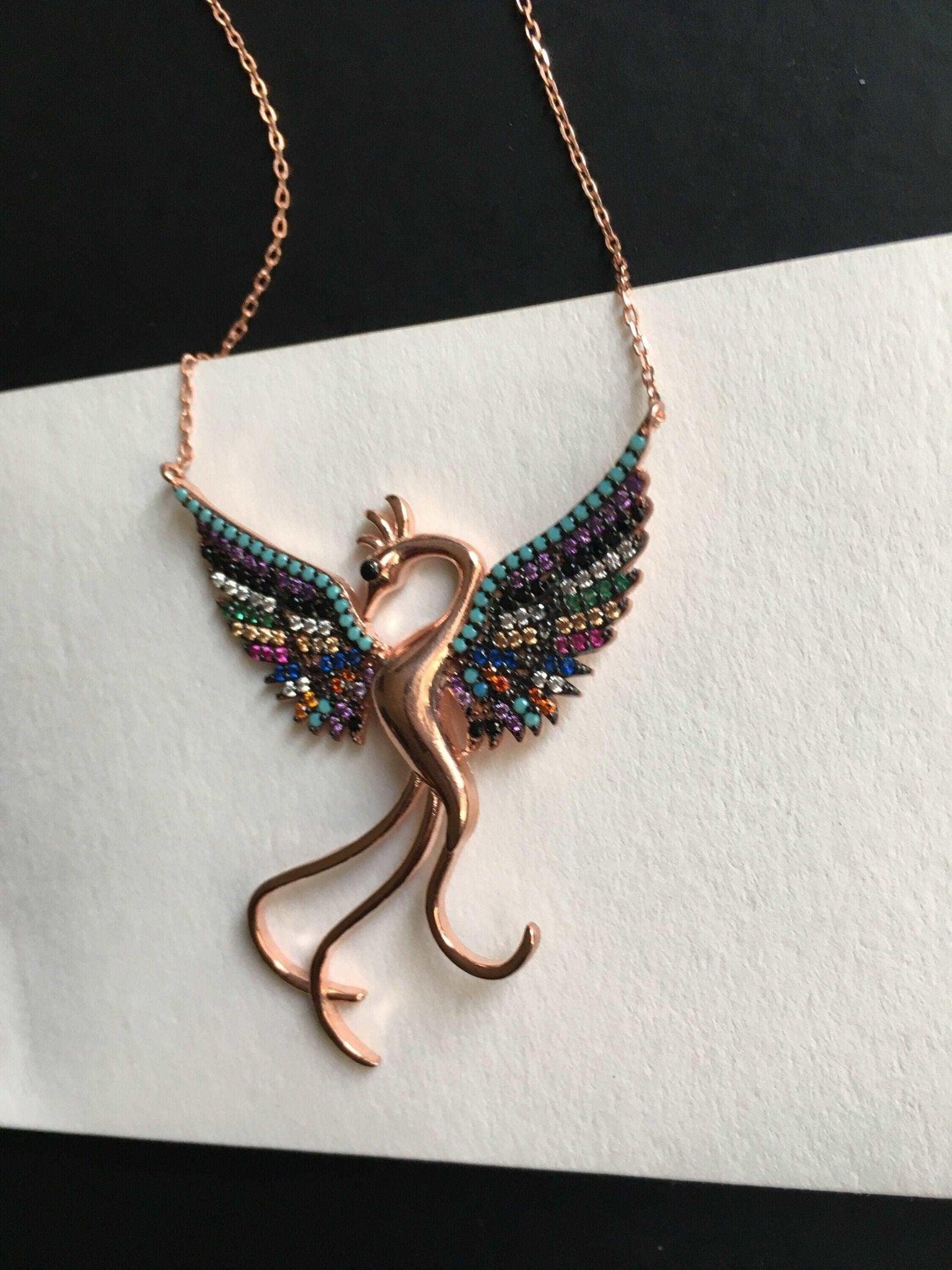 Rainbow Phoenix Necklace,Custom Desing Firebird Handmade Jewelry StrenWe designed our 925 carat fire bird necklace for you. It is completely handcrafted and made of sterling silver. It is decorated with rose gold and colored zircon stoRainbow Phoenix Necklace