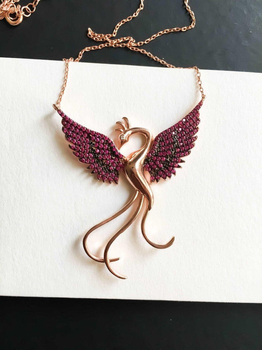 Red Phoenix Handmade Necklace, Bird Jewelry Rose Gold Firebird PendantWe designed our 925 carat fire bird necklace for you. It is completely handcrafted and made of sterling silver. It is decorated with rose gold and Purple colored zirRed Phoenix Handmade Necklace