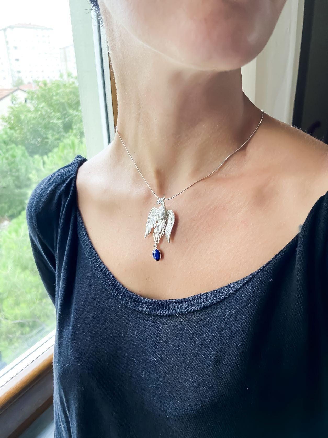Silver Lapis Lazuli Phoenix Strength Necklace, Sapphire Stone or Root Lapis Lazuli Stone Sapphire or Root Ruby Eyes Pure Silver Our phoenix is ​​925 sterling silver and it is completely handcrafted. The eyes you see on it are decoratedSilver Lapis Lazuli