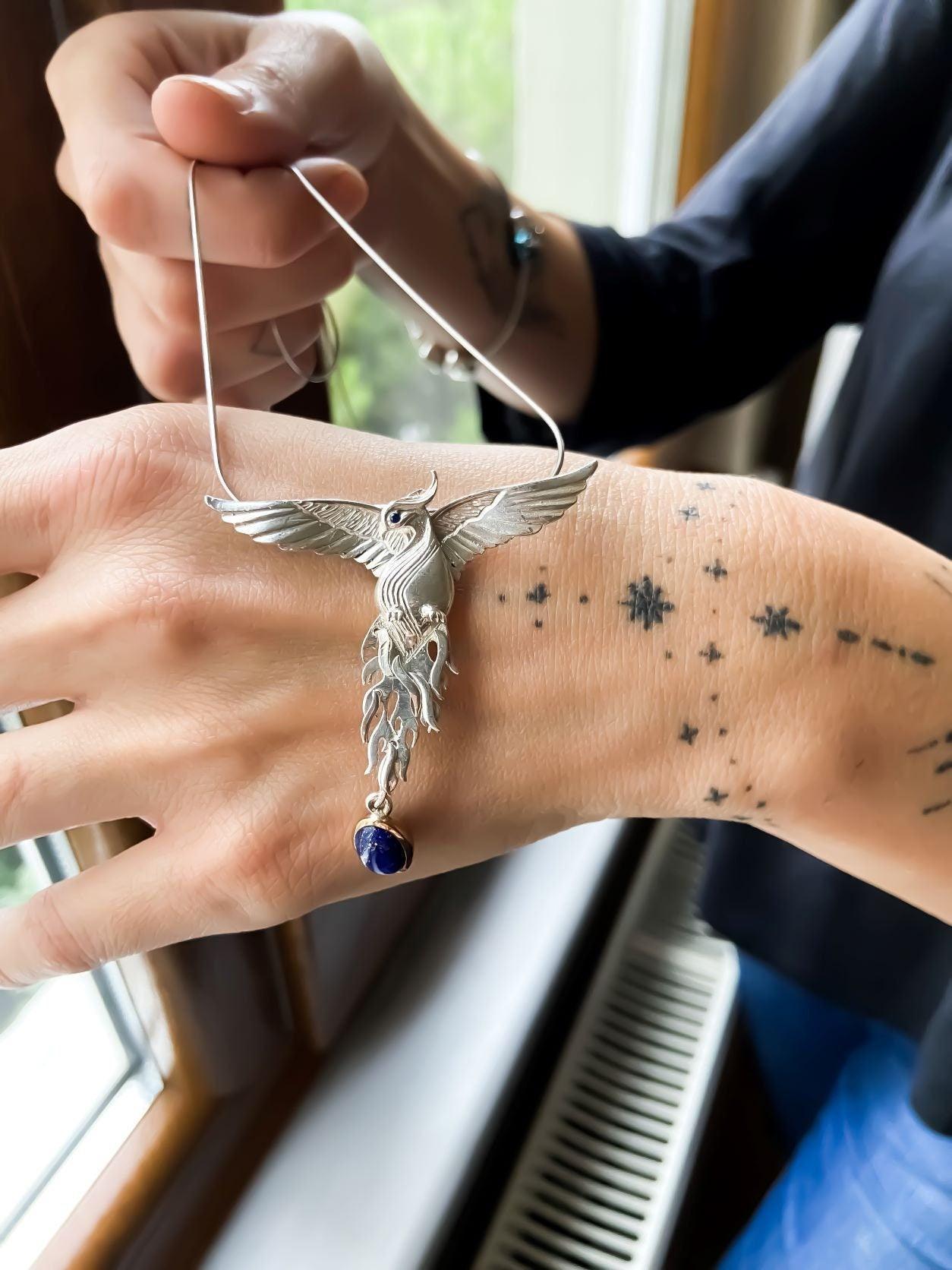 Silver Lapis Lazuli Phoenix Strength Necklace, Sapphire Stone or Root Lapis Lazuli Stone Sapphire or Root Ruby Eyes Pure Silver Our phoenix is ​​925 sterling silver and it is completely handcrafted. The eyes you see on it are decoratedSilver Lapis Lazuli