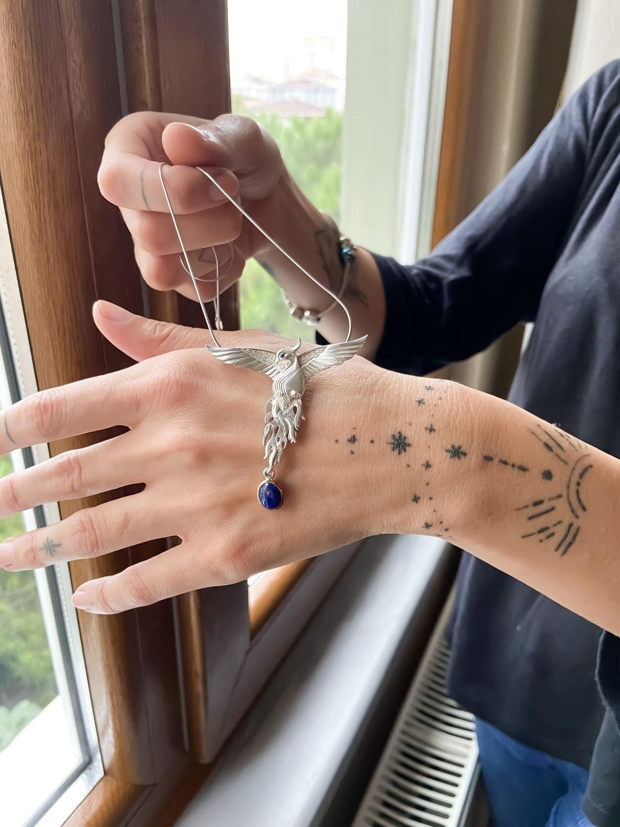Silver Lapis Lazuli Phoenix Strength Necklace, Sapphire Stone or Root Lapis Lazuli Stone Sapphire or Root Ruby Eyes Pure Silver Our phoenix is ​​925 sterling silver and it is completely handcrafted. The eyes you see on it are decoratedSilver Lapis Lazuli