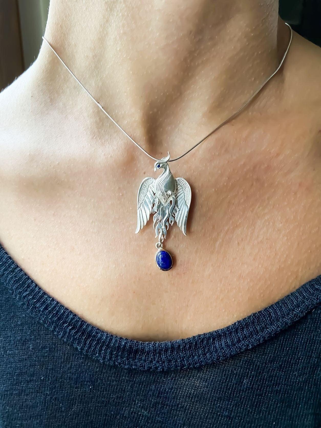 Silver Lapis Lazuli Phoenix Strength Necklace, Sapphire Stone or Root Lapis Lazuli Stone Sapphire or Root Ruby Eyes Pure Silver Our phoenix is ​​925 sterling silver and it is completely handcrafted. The eyes you see on it are decoratedSilver Lapis Lazuli