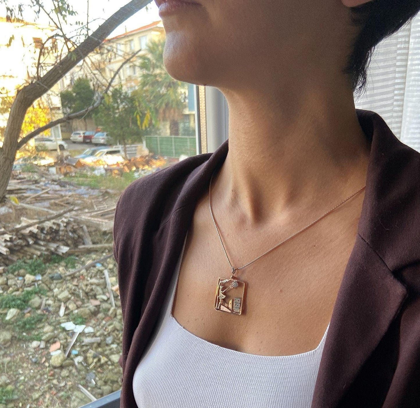 Windy Weather Rose Gold 3-D Necklace, Girl and Stormy City Holding Umb925 Sterling Silver Windy Weather Rose Gold 3-D Necklace For Women.
A girl is carrying an umbrella fighting against the wind. The city is in the background and the gWindy Weather Rose Gold