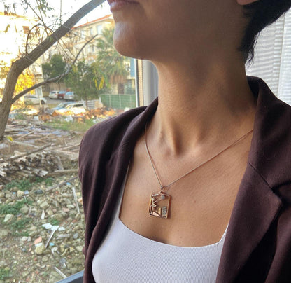 Windy Weather Rose Gold 3-D Necklace, Girl and Stormy City Holding Umb925 Sterling Silver Windy Weather Rose Gold 3-D Necklace For Women.
A girl is carrying an umbrella fighting against the wind. The city is in the background and the gWindy Weather Rose Gold