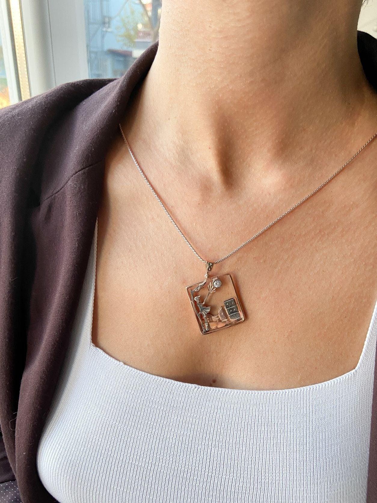 Windy Weather Rose Gold 3-D Necklace, Girl and Stormy City Holding Umb925 Sterling Silver Windy Weather Rose Gold 3-D Necklace For Women.
A girl is carrying an umbrella fighting against the wind. The city is in the background and the gWindy Weather Rose Gold