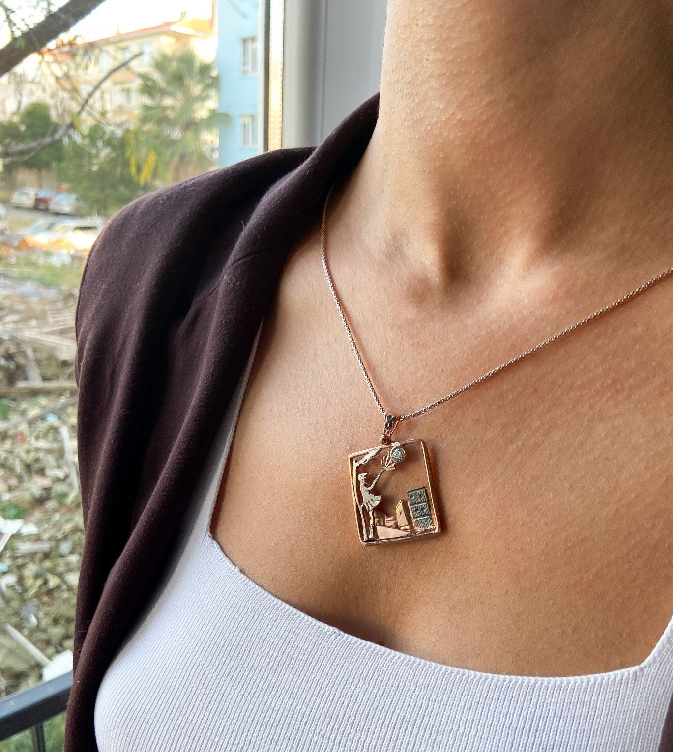 Windy Weather Rose Gold 3-D Necklace, Girl and Stormy City Holding Umb925 Sterling Silver Windy Weather Rose Gold 3-D Necklace For Women.
A girl is carrying an umbrella fighting against the wind. The city is in the background and the gWindy Weather Rose Gold